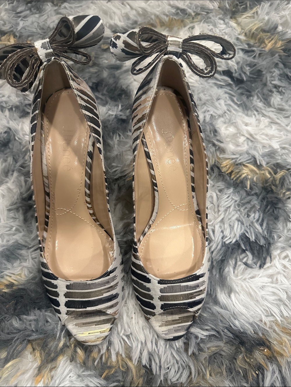 J. Renee open-toe pumps, distinctive tribal/striped design and a prominent bow.